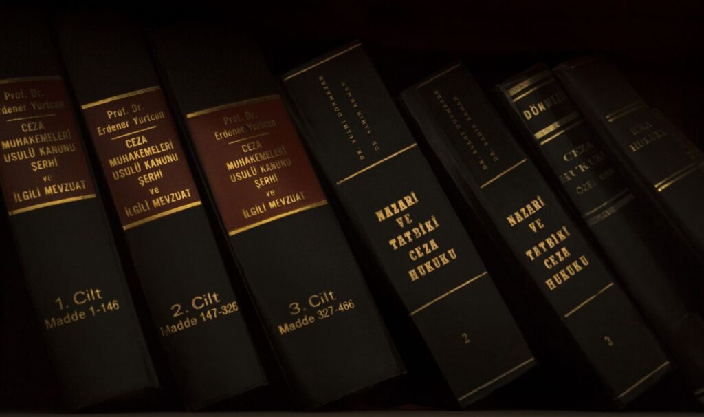Stack of legal and literature books in a library showcasing various volumes.