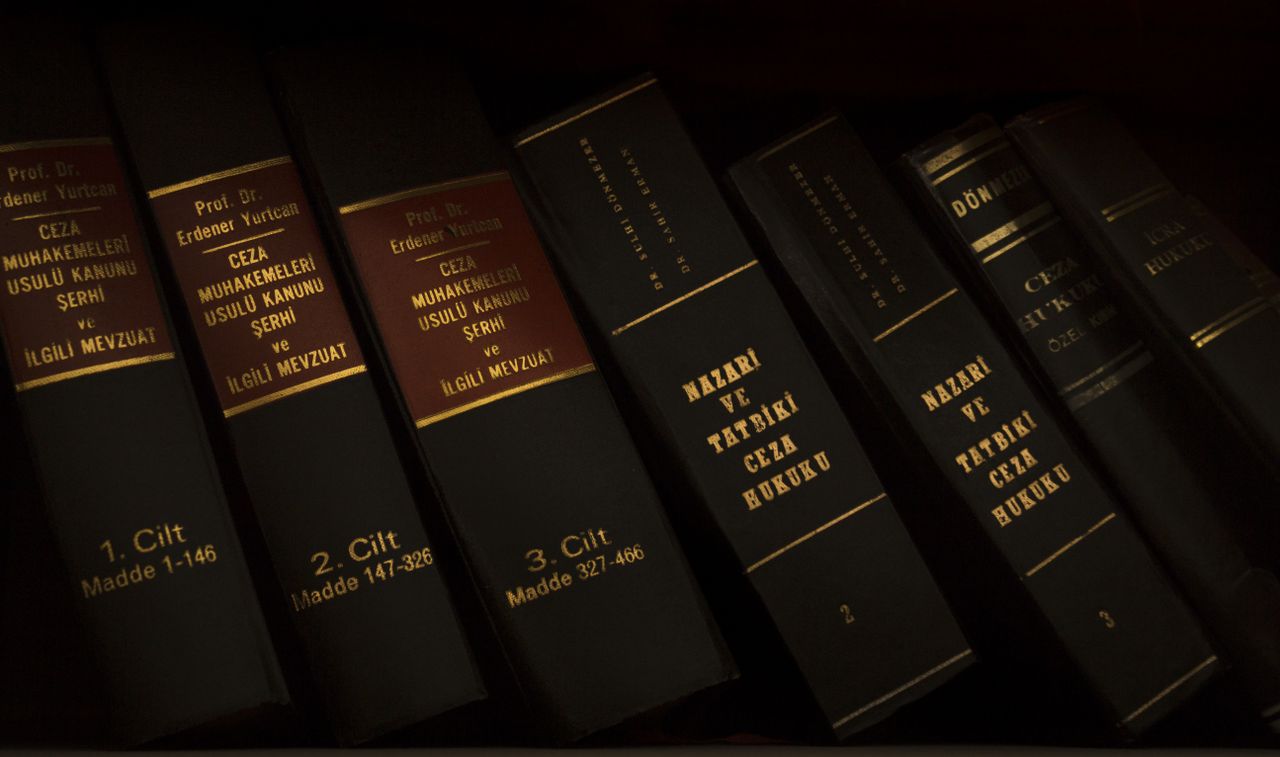 Stack of legal and literature books in a library showcasing various volumes.